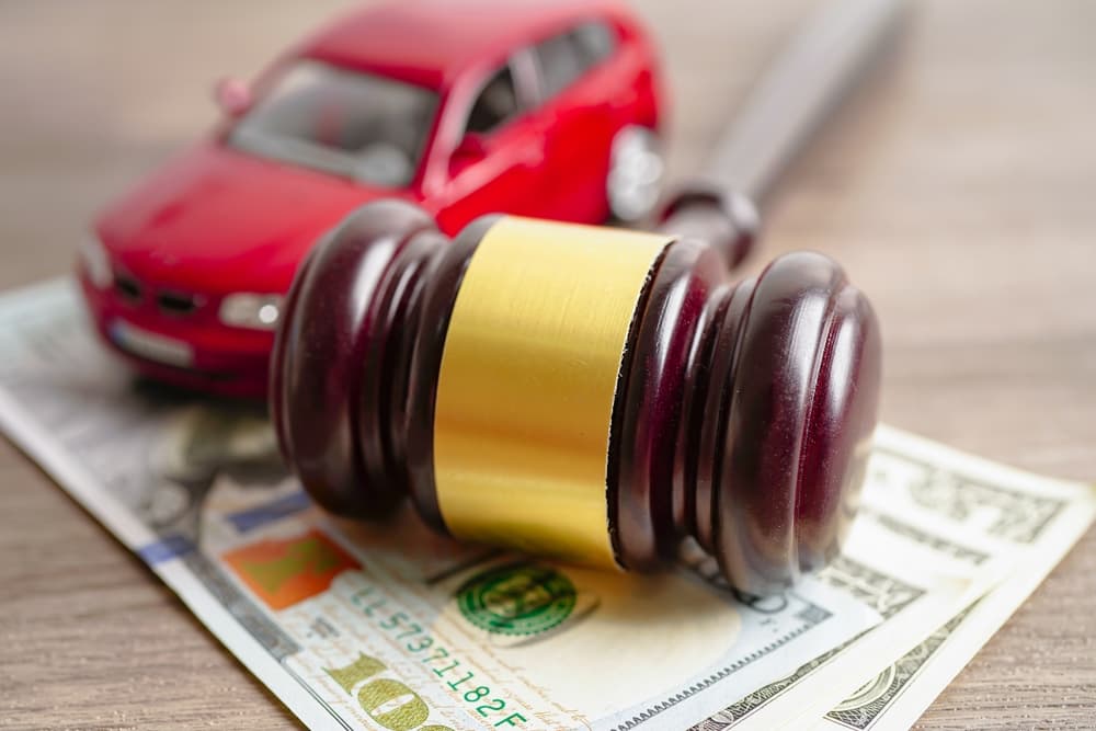 Gavel for judge lawyer with car on US dollar money banknotes