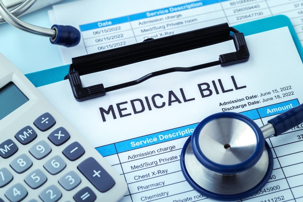 Medical bill concept on blue background, hospital payment and health care cost