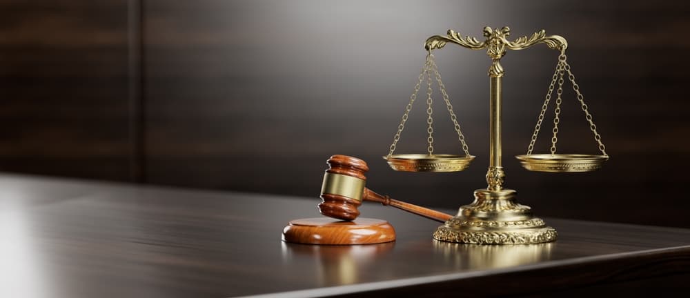 The scales of justice and the judge's gavel serve as symbols of law and order.






