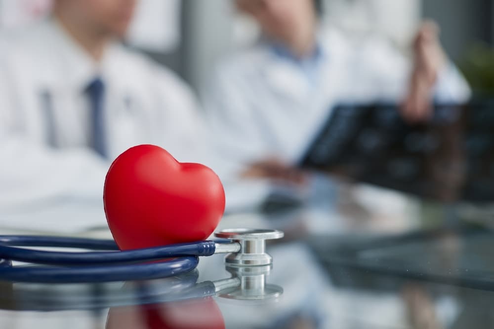 male hands with red hearts, top view. Cardiology concept